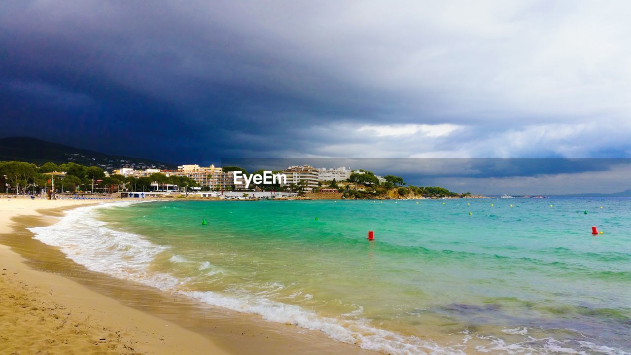 View of beach against cloudy sky