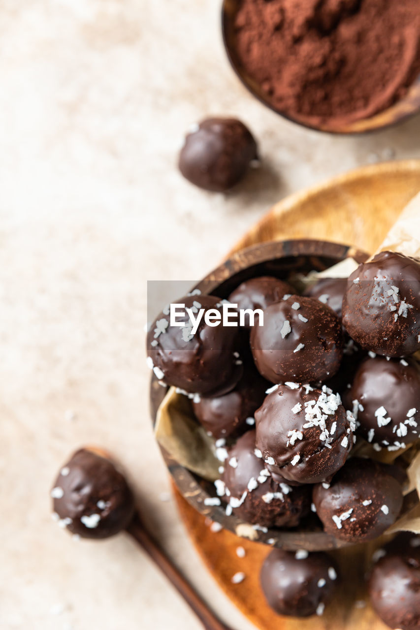 food and drink, food, chocolate, dessert, sweet food, produce, freshness, chocolate balls, sweet, chocolate ice cream, indoors, no people, spoon, studio shot, brown, healthy eating, wood, confiture, fruit, close-up, eating utensil, kitchen utensil, snack, still life, chocolate brownie