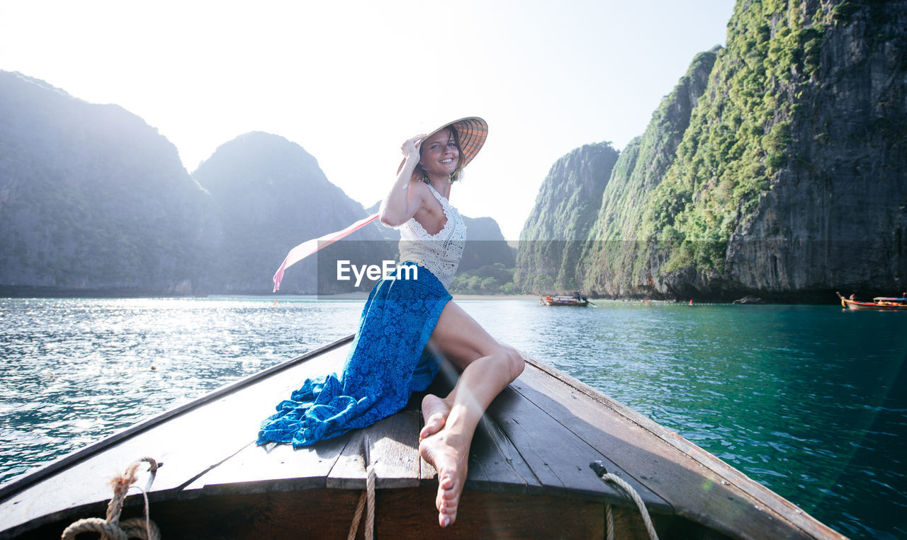 Woman on longtail boat in sea