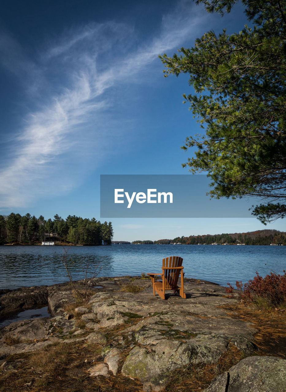 Scenic view of muskoka chair and lake against sky