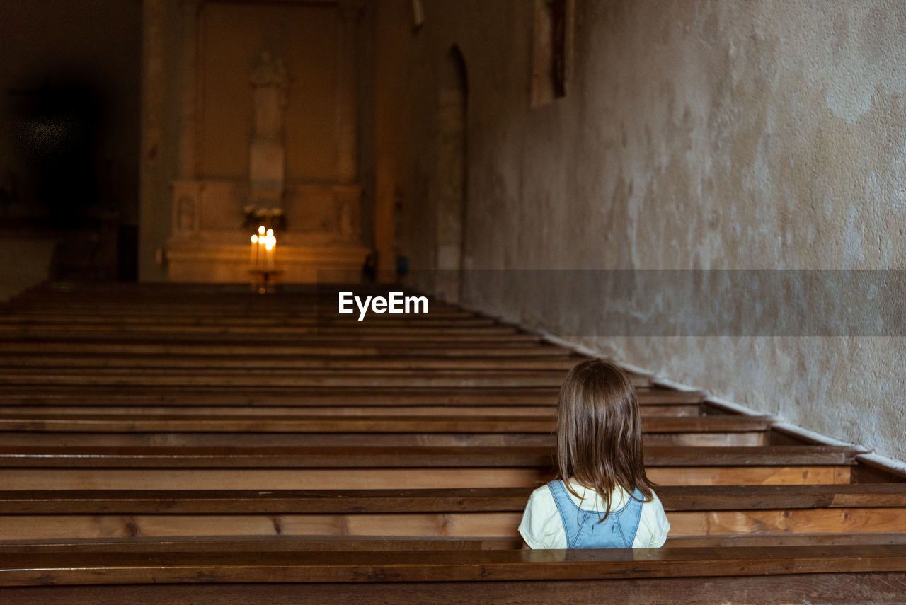 Girl sitting in church 