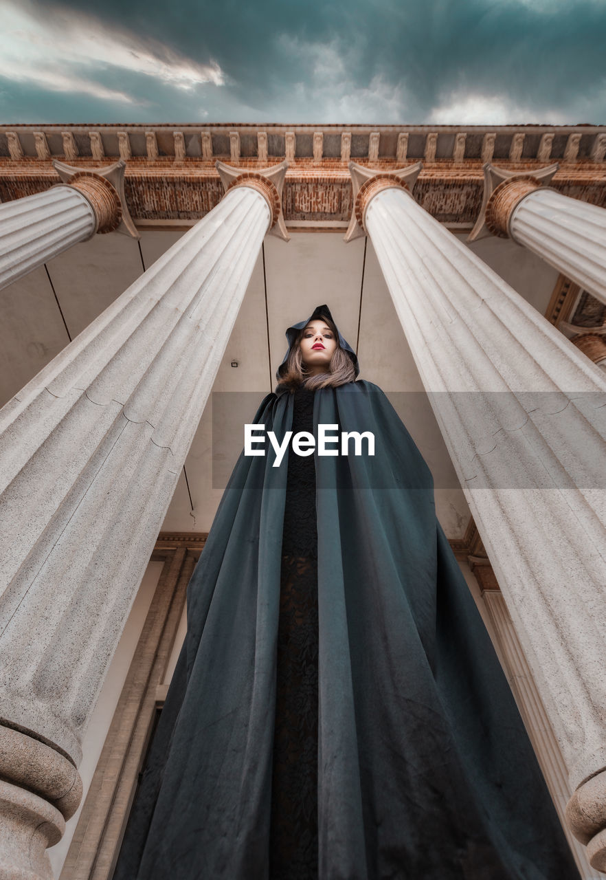 Portrait of woman standing against sky