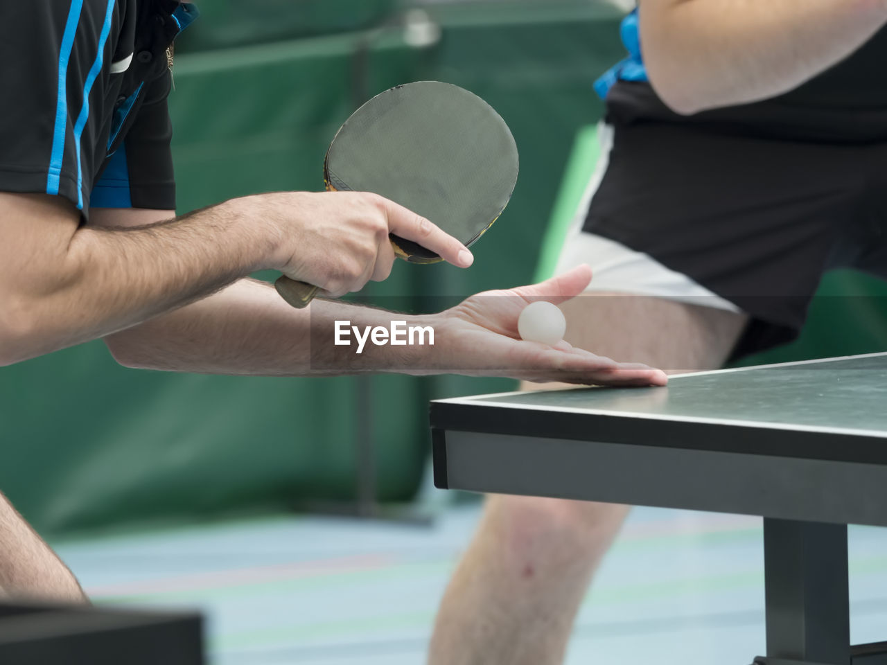 Midsection of man playing table tennis