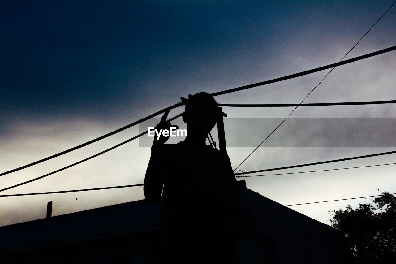 LOW ANGLE VIEW OF SILHOUETTE PERSON ON SKY