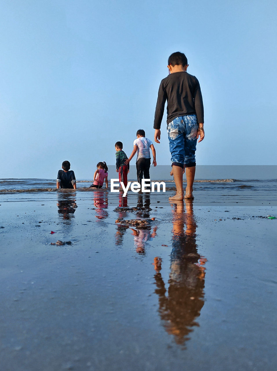 People on beach against sky