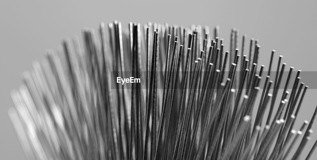 Close-up of metallic wire against gray background