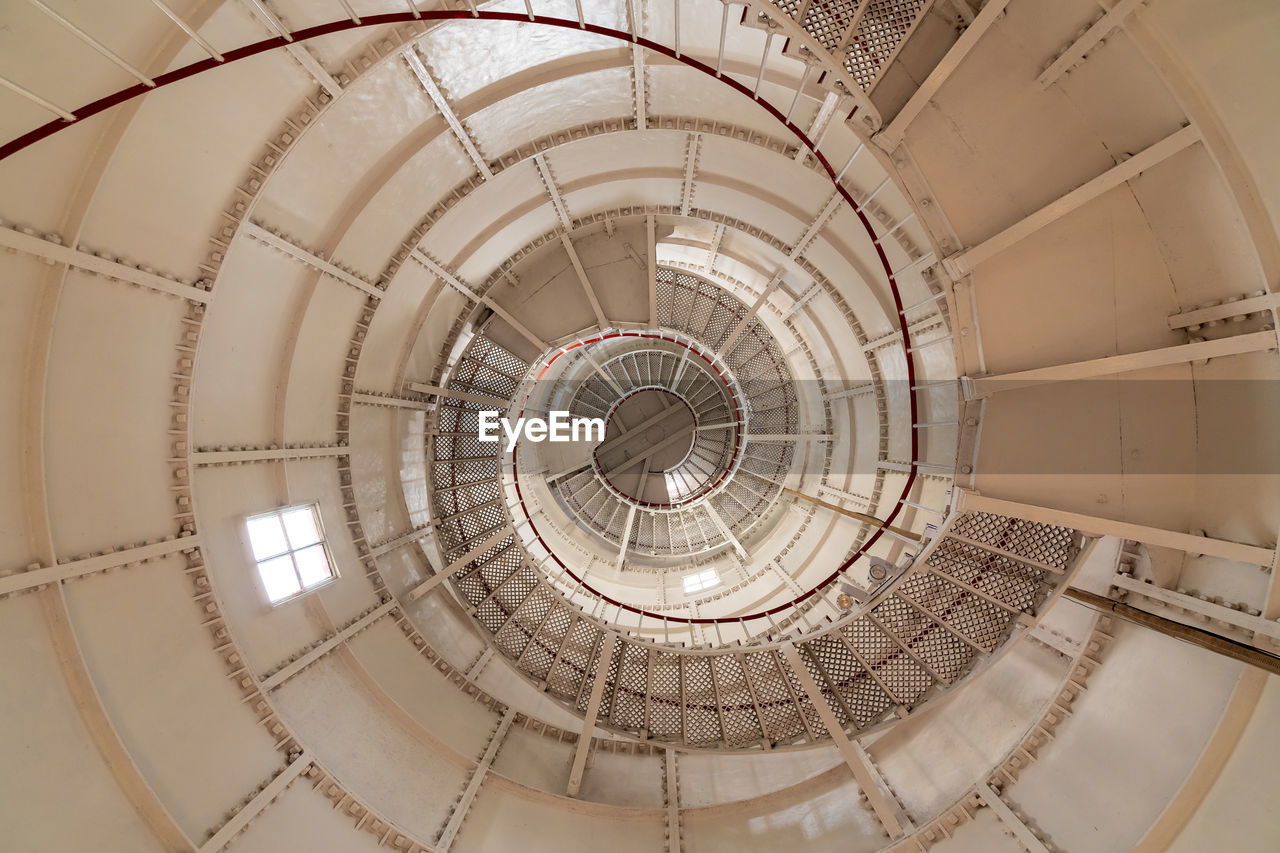 DIRECTLY BELOW SHOT OF SPIRAL STAIRCASE IN BUILDING