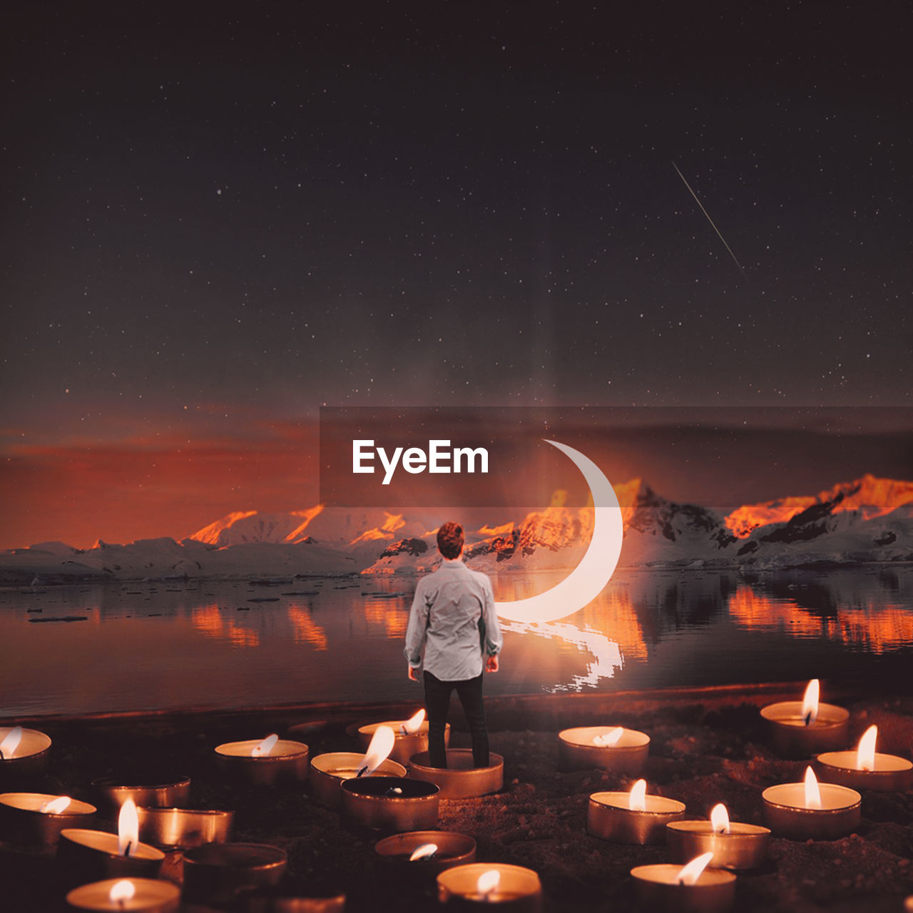 Digital composite image of man standing in tea light candle against lake and moon at night