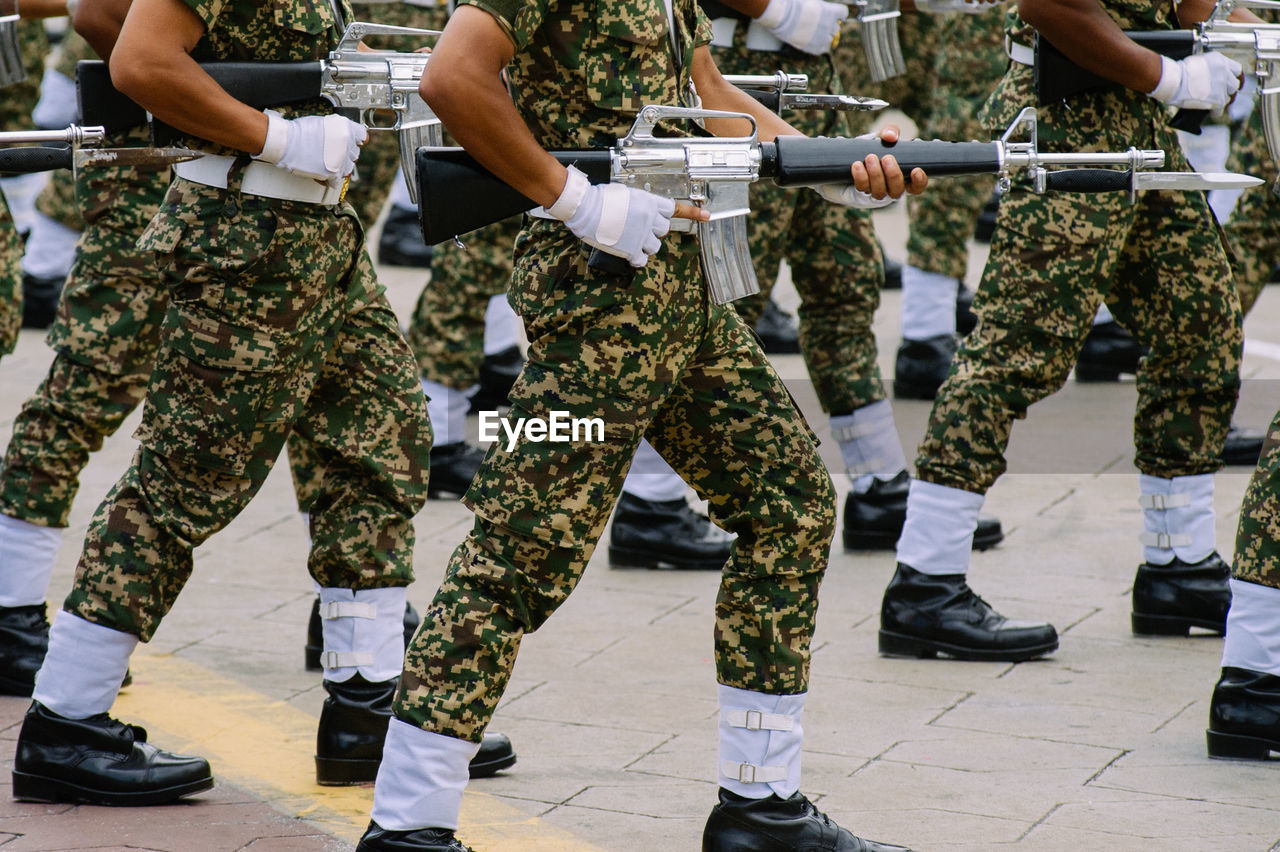 Low section of army soldiers with rifle during parade