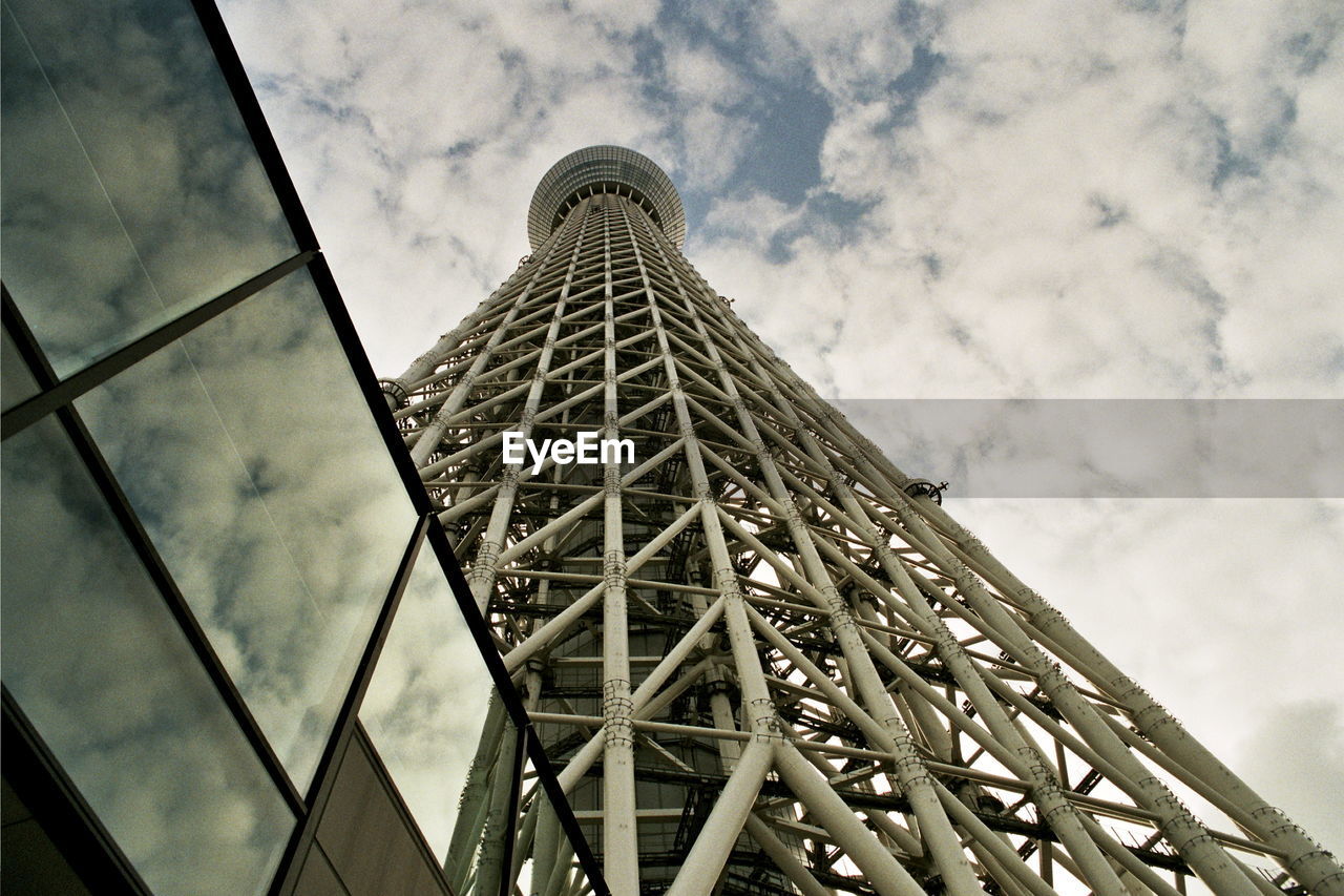 Low angle view of tokyo sky tree against cloudy sky in city