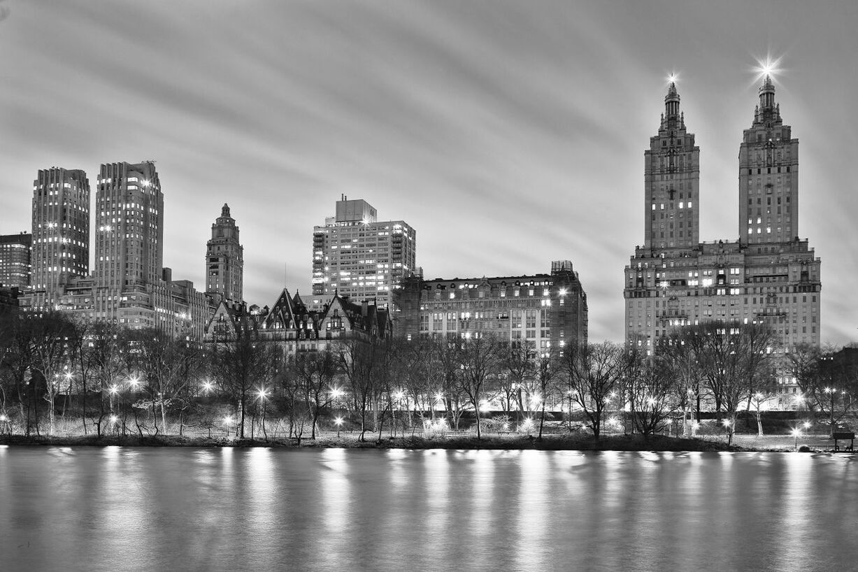 Illuminated buildings at night with waterfront