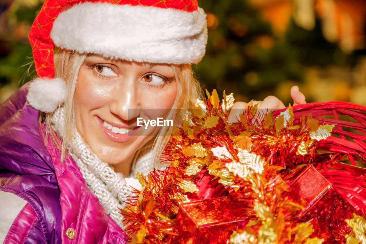 Close-up of happy mature woman holding christmas presents
