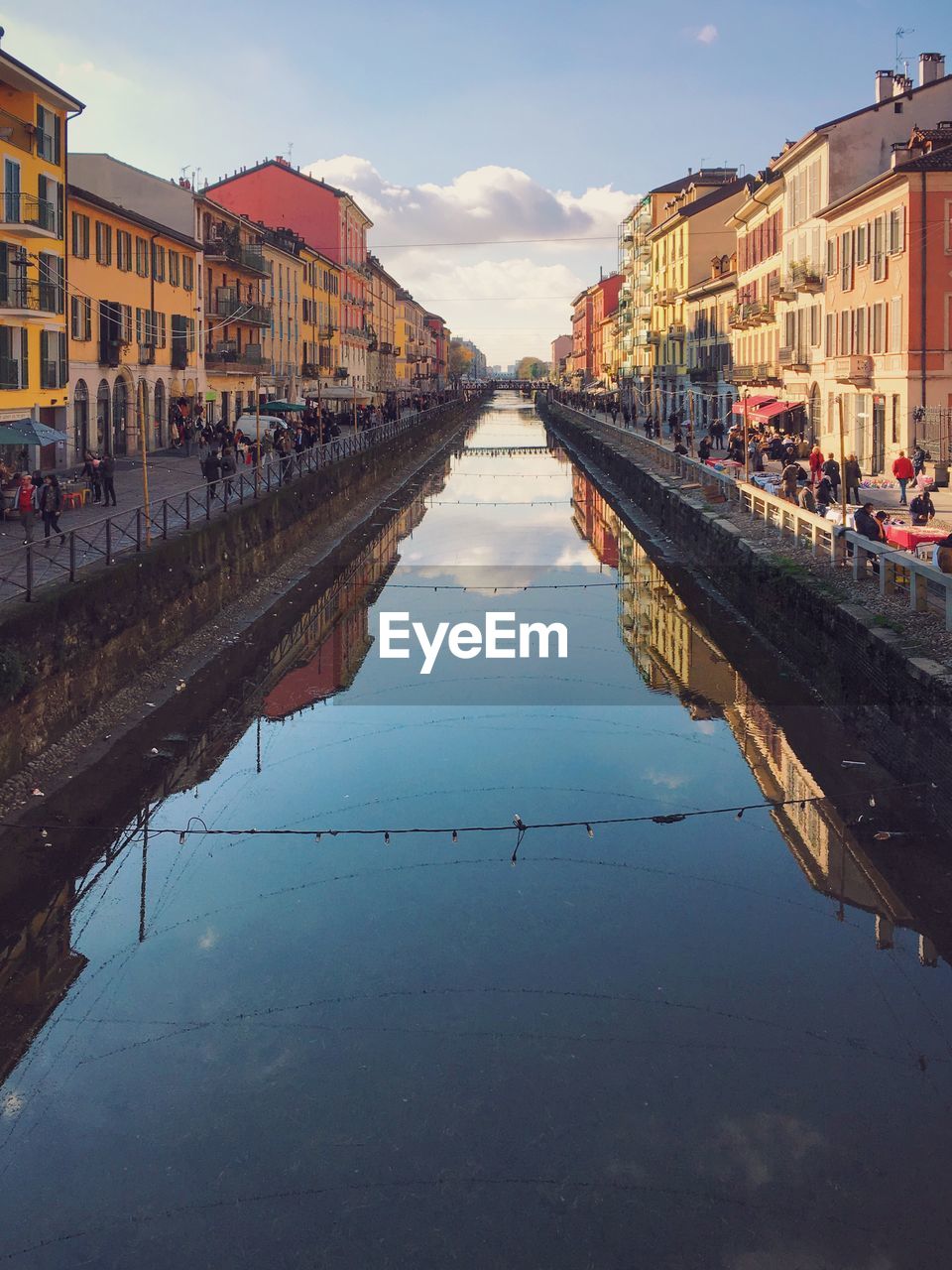 Naviglio grande amidst buildings against sky