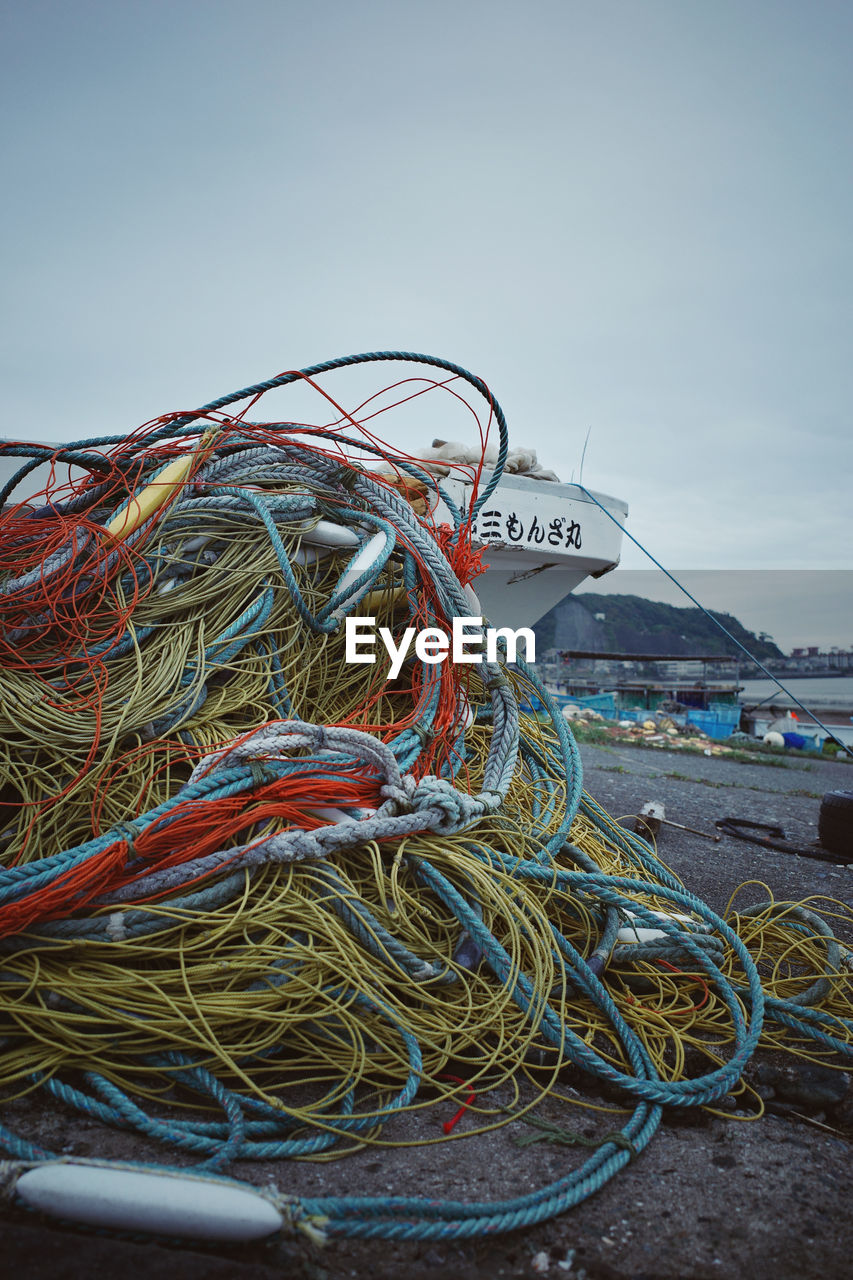 STACK OF FISHING NET AT HARBOR