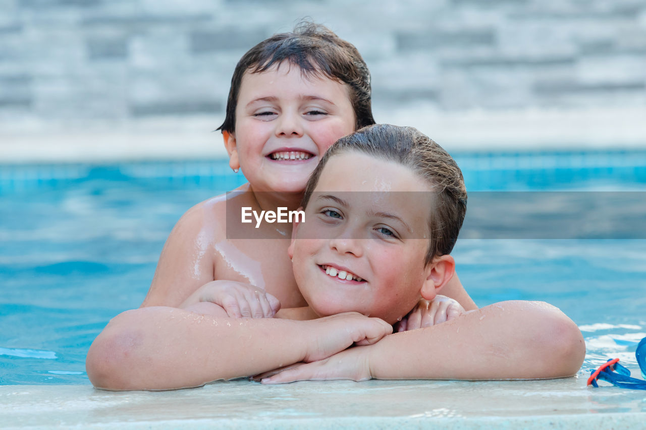 Portrait of kids in swimming pool