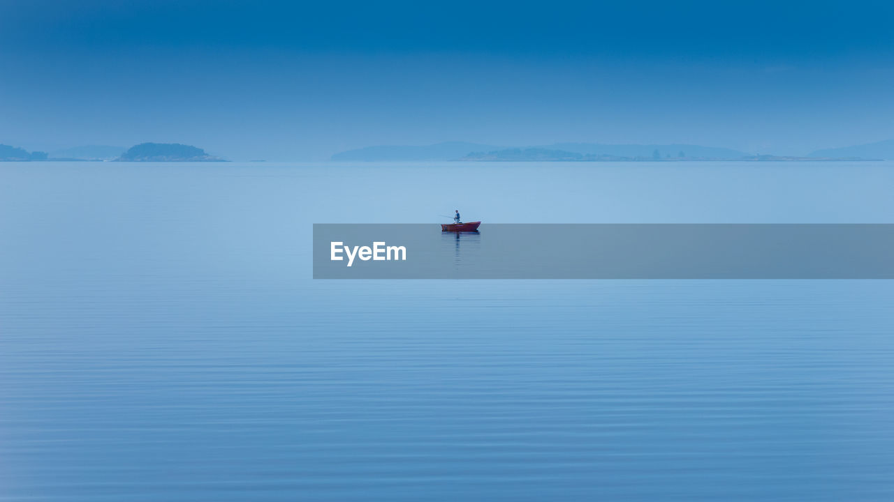 Scenic view of lake against blue sky