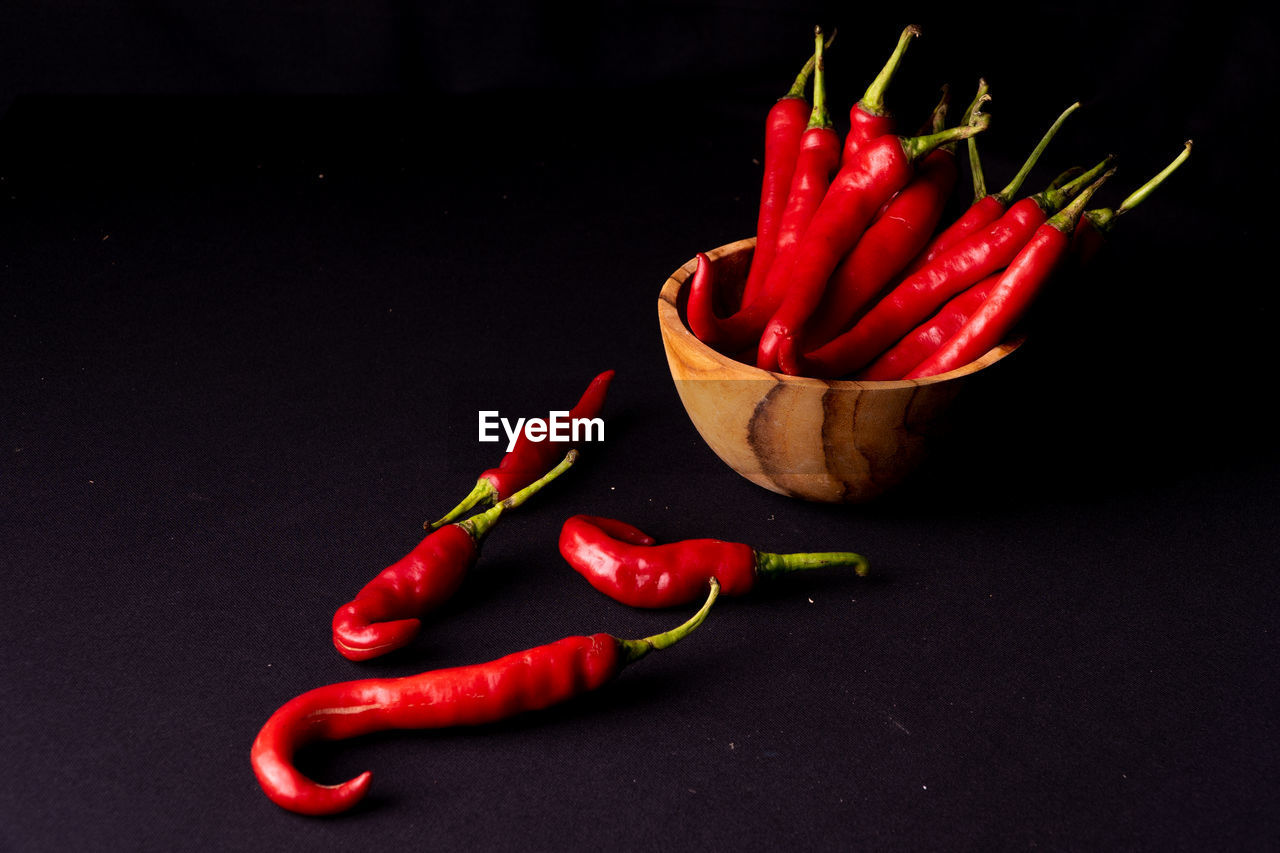 CLOSE-UP OF RED CHILI PEPPERS ON TABLE