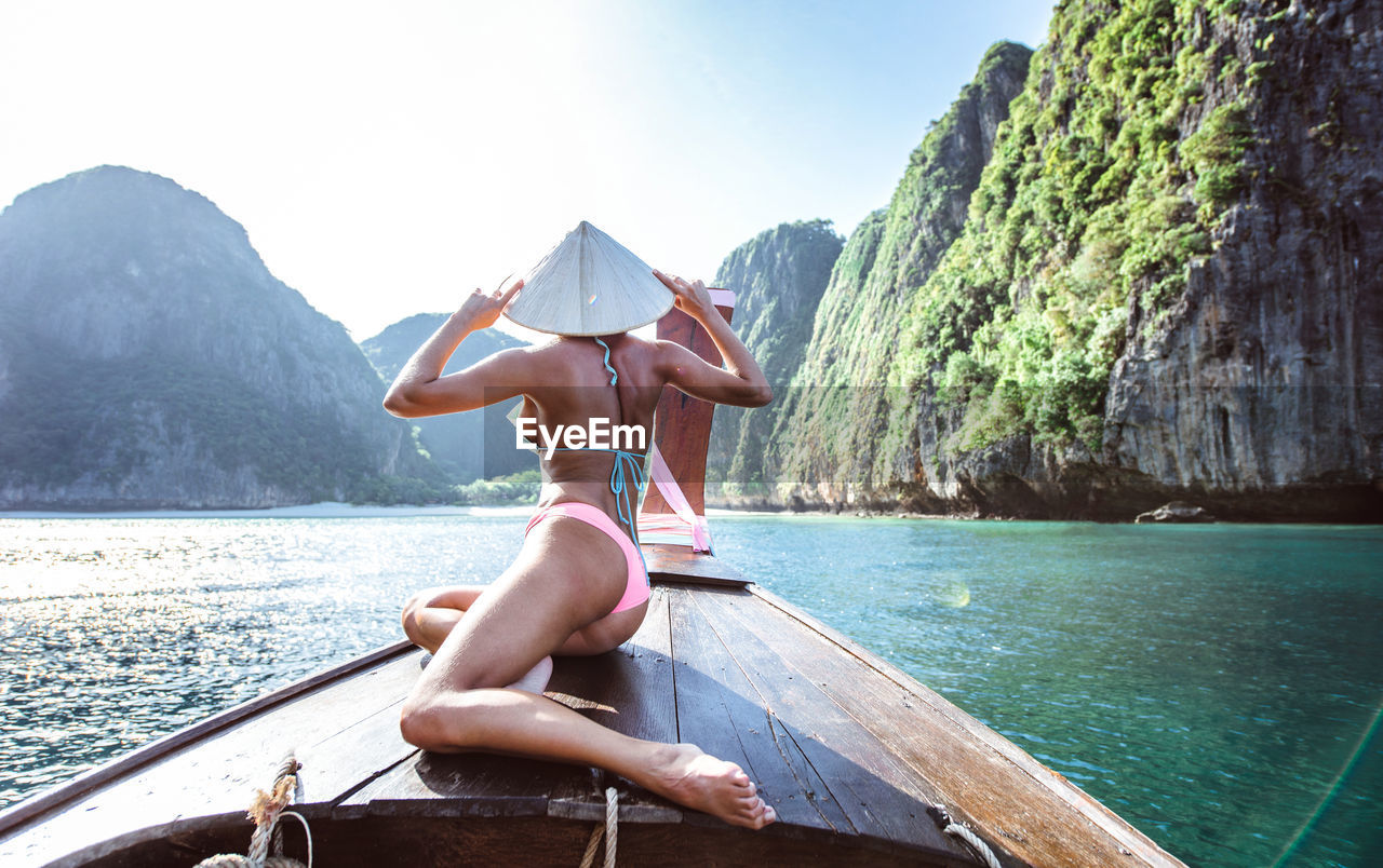 Woman on longtail boat in sea