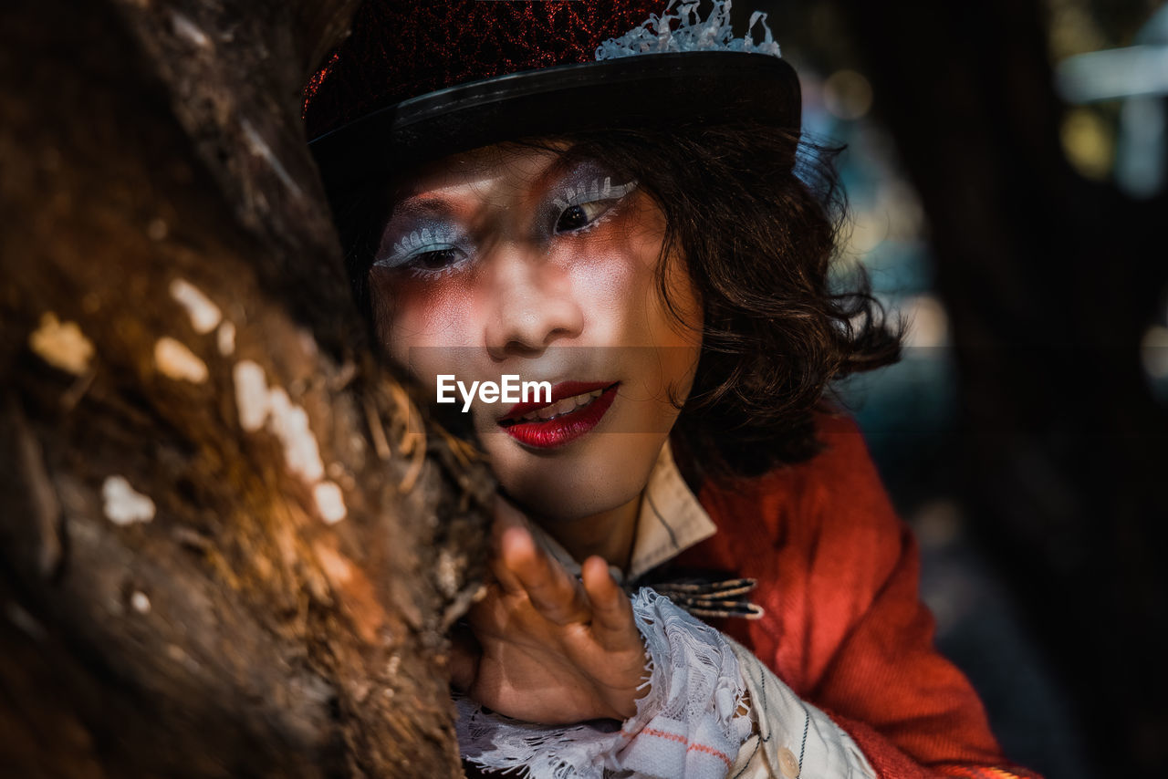 Portrait of a boy in shadows look at tree branch