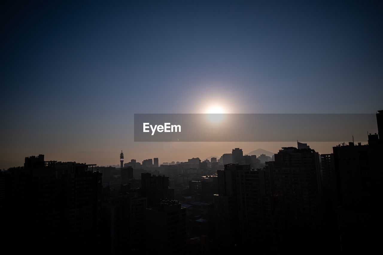 Silhouette buildings against sky during eclipse