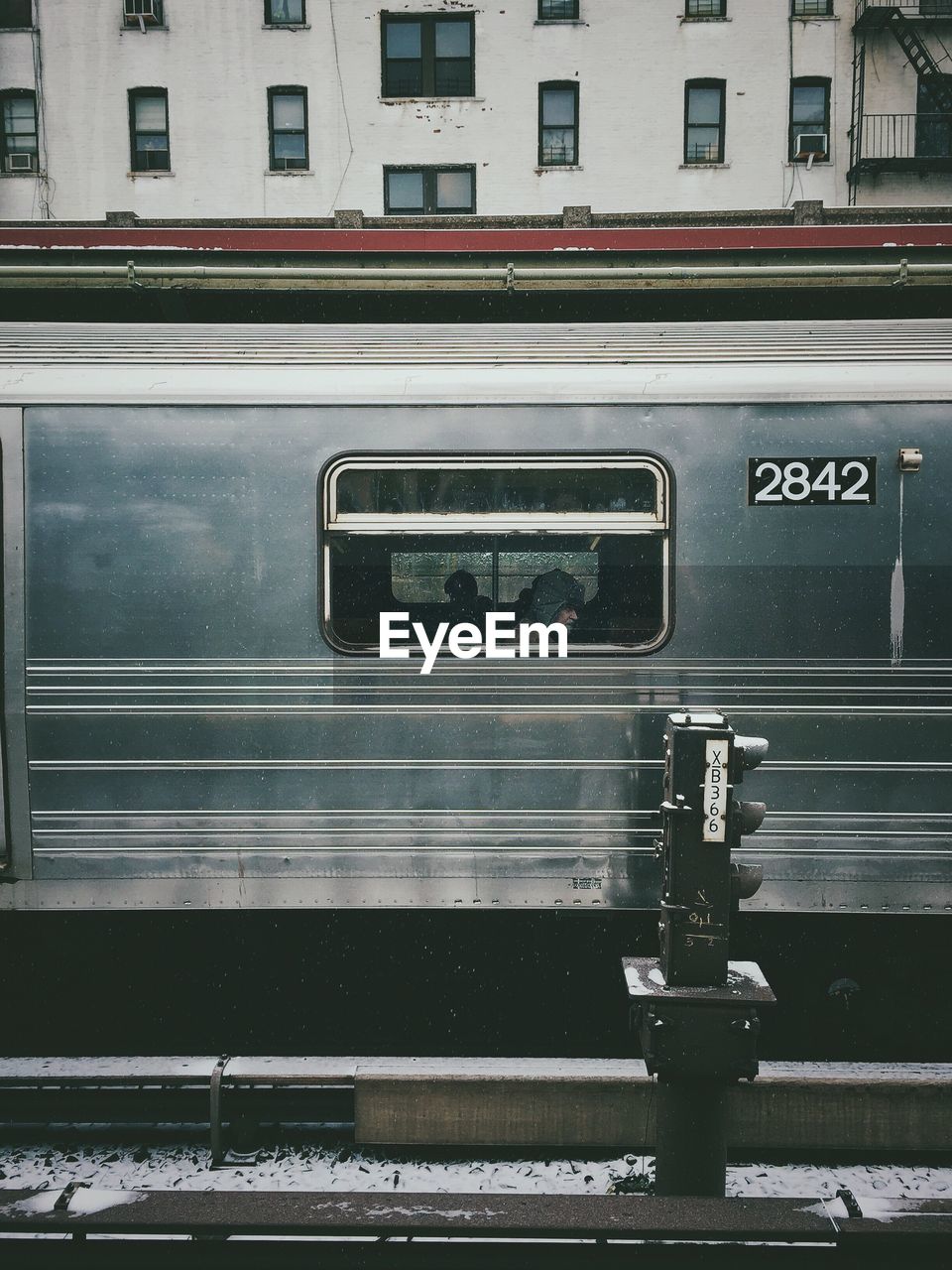 Man seen through window in train