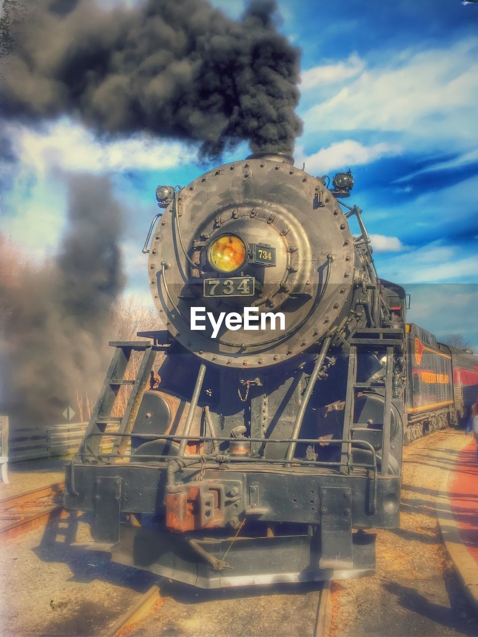 Steam locomotive on tracks against sky