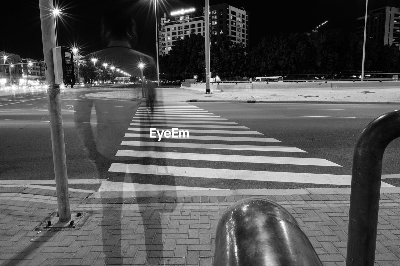 Double exposure of men crossing road