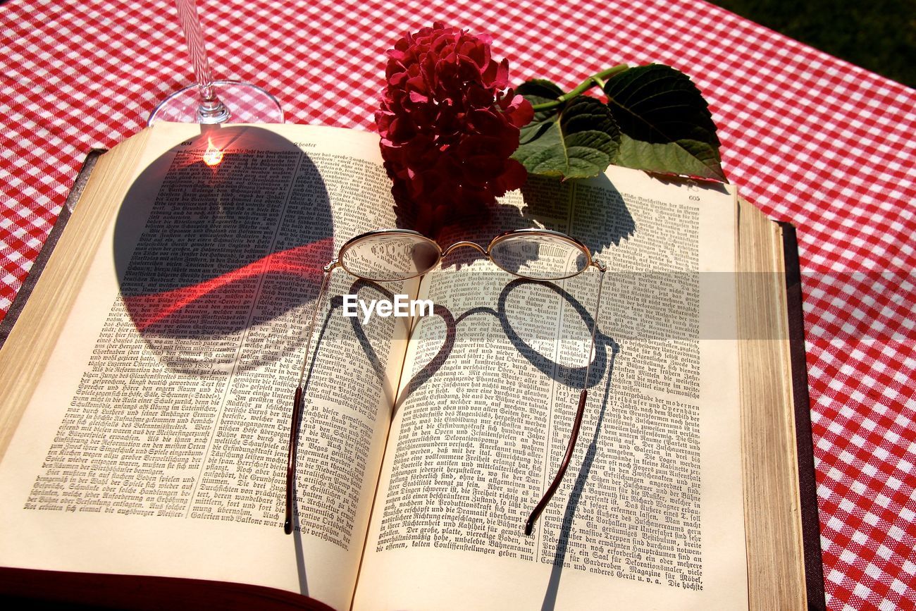 Reflection Of Wineglass In Open Book On Table Id 70578412