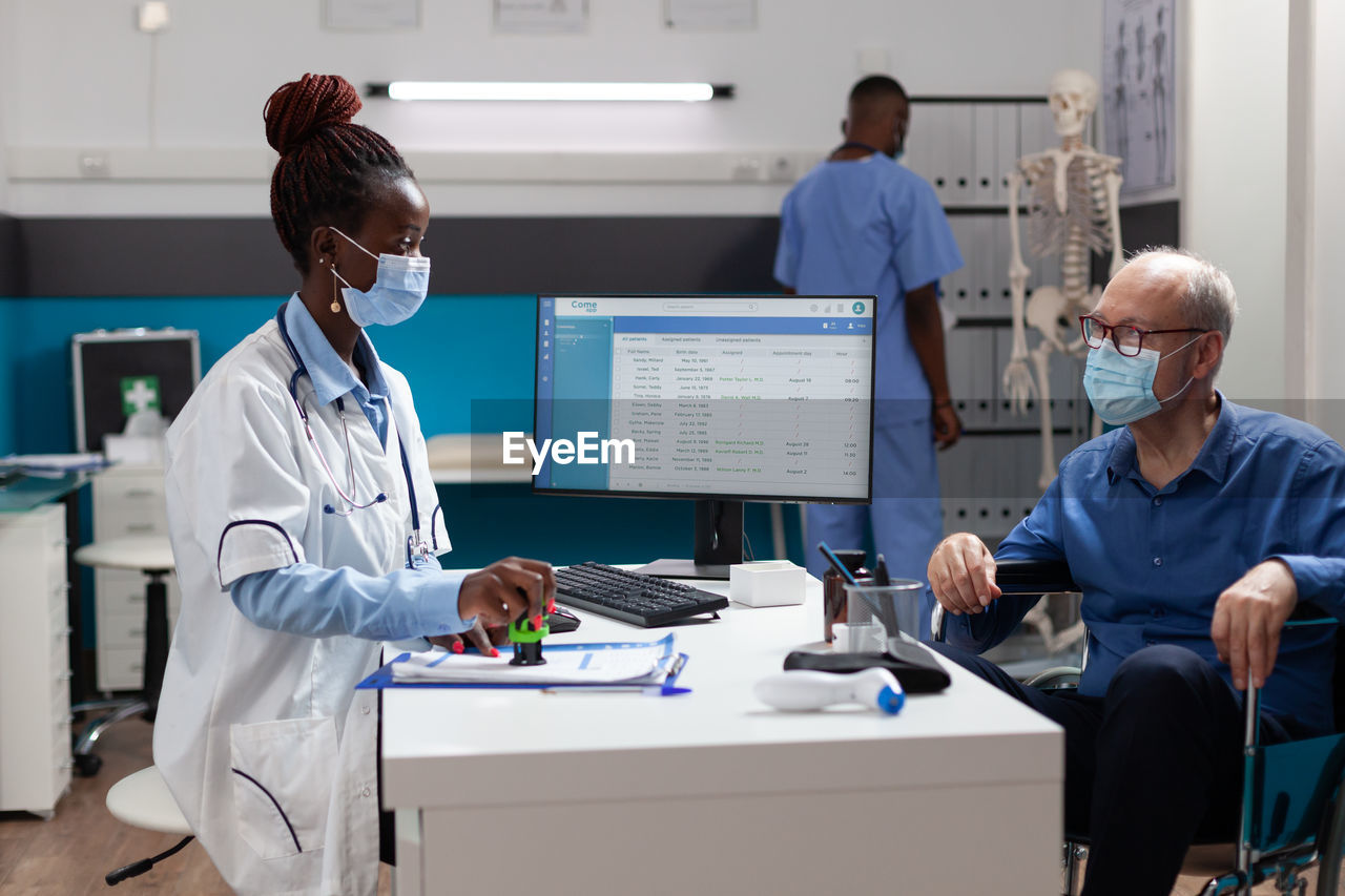 female doctor examining patient in office