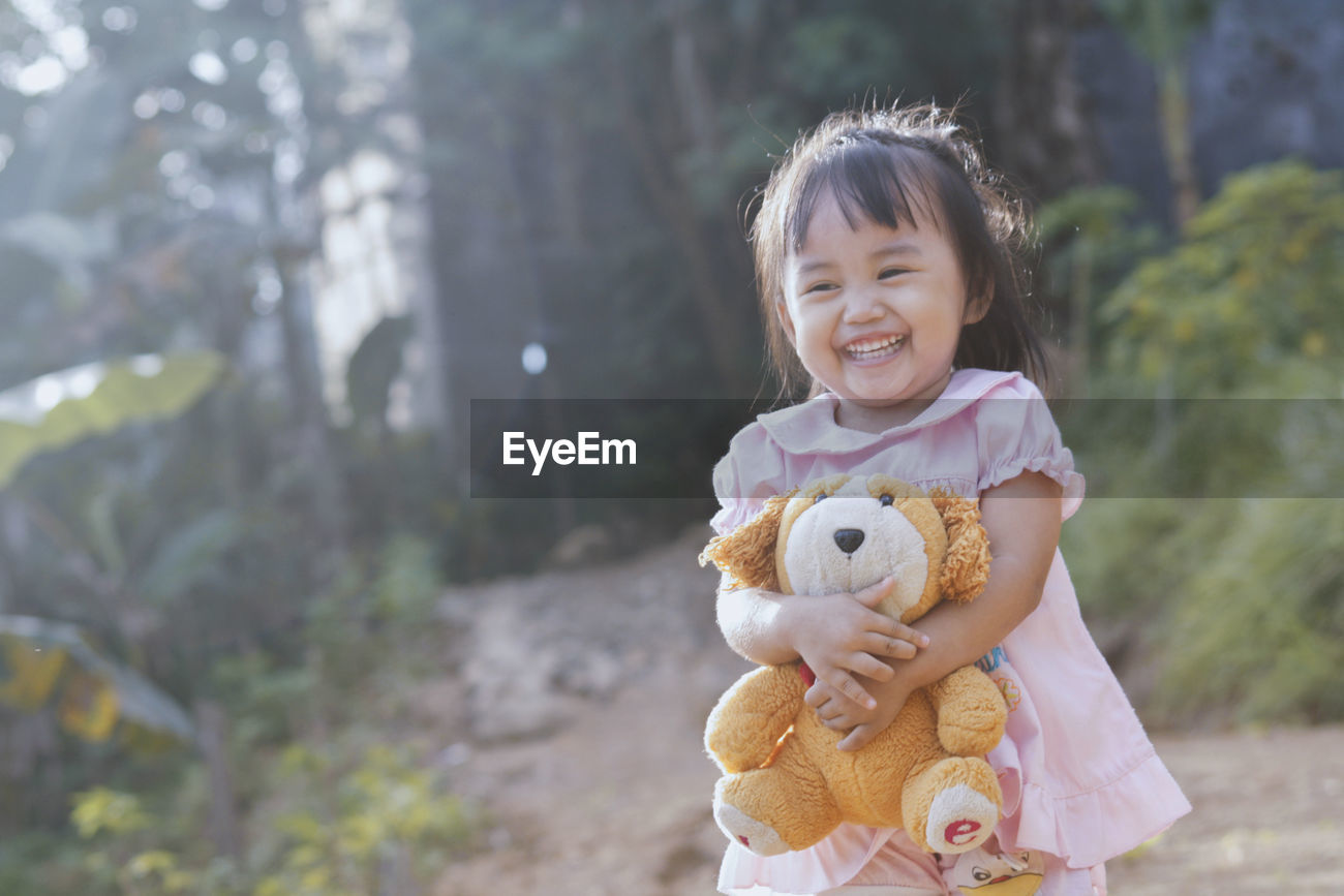 girl holding teddy bear