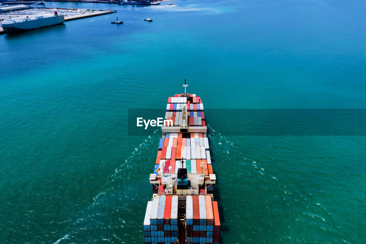 High angle view of  shipping containers sailing in sea