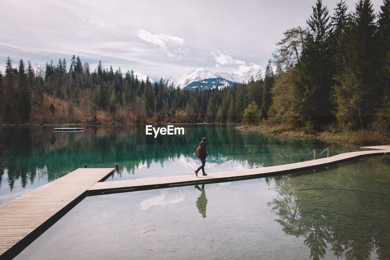 Person walking on pier at caumasee lake