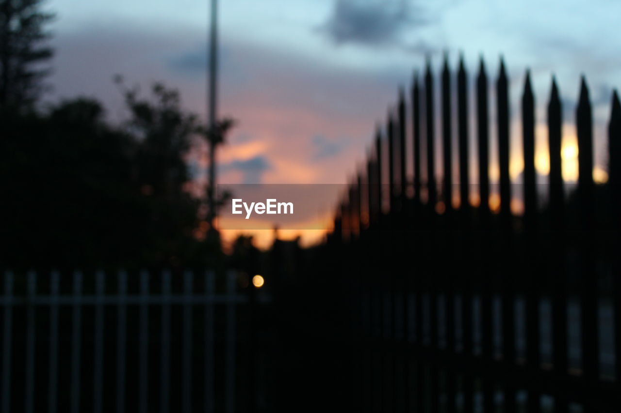 VIEW OF FENCE AT SUNSET