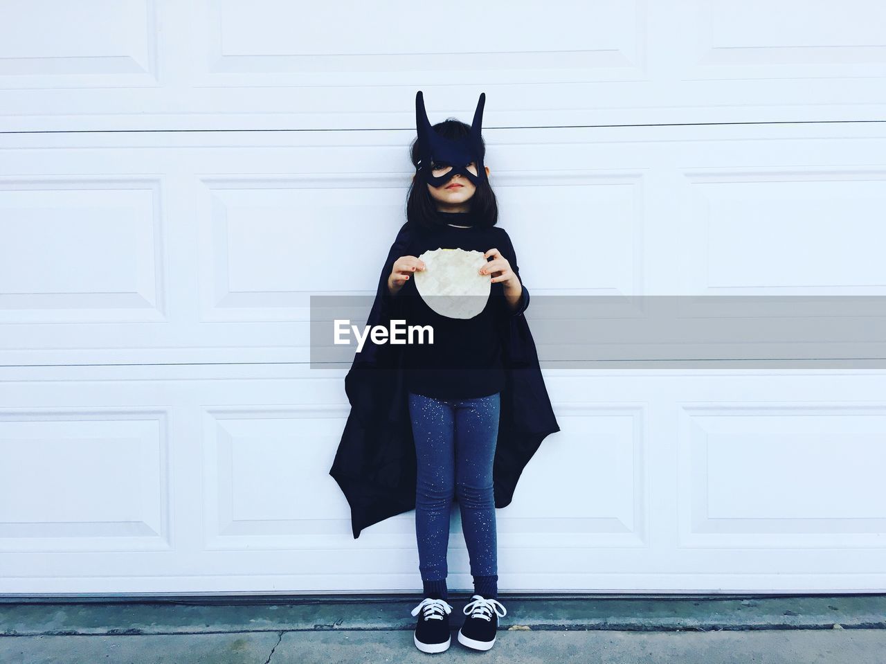 Portrait of a girl wearing batman mask