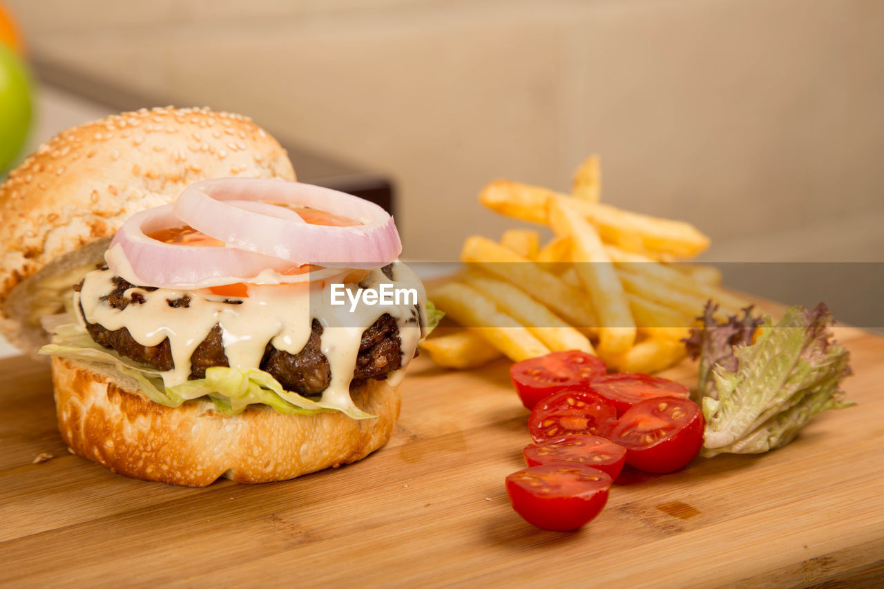 Close-up of burger with french fries on table