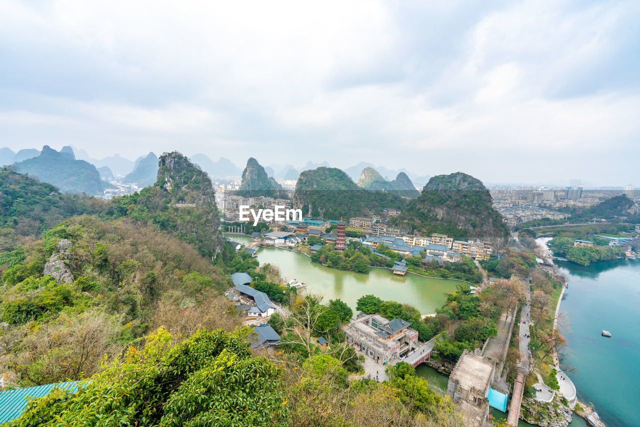 High angle view of river and cityscape against sky