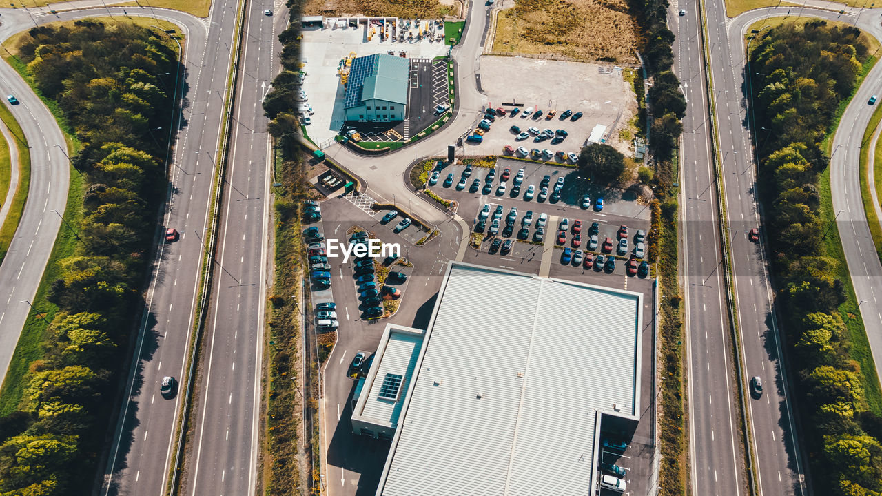 Aerial view of shopping mall parking lot with highway nearby