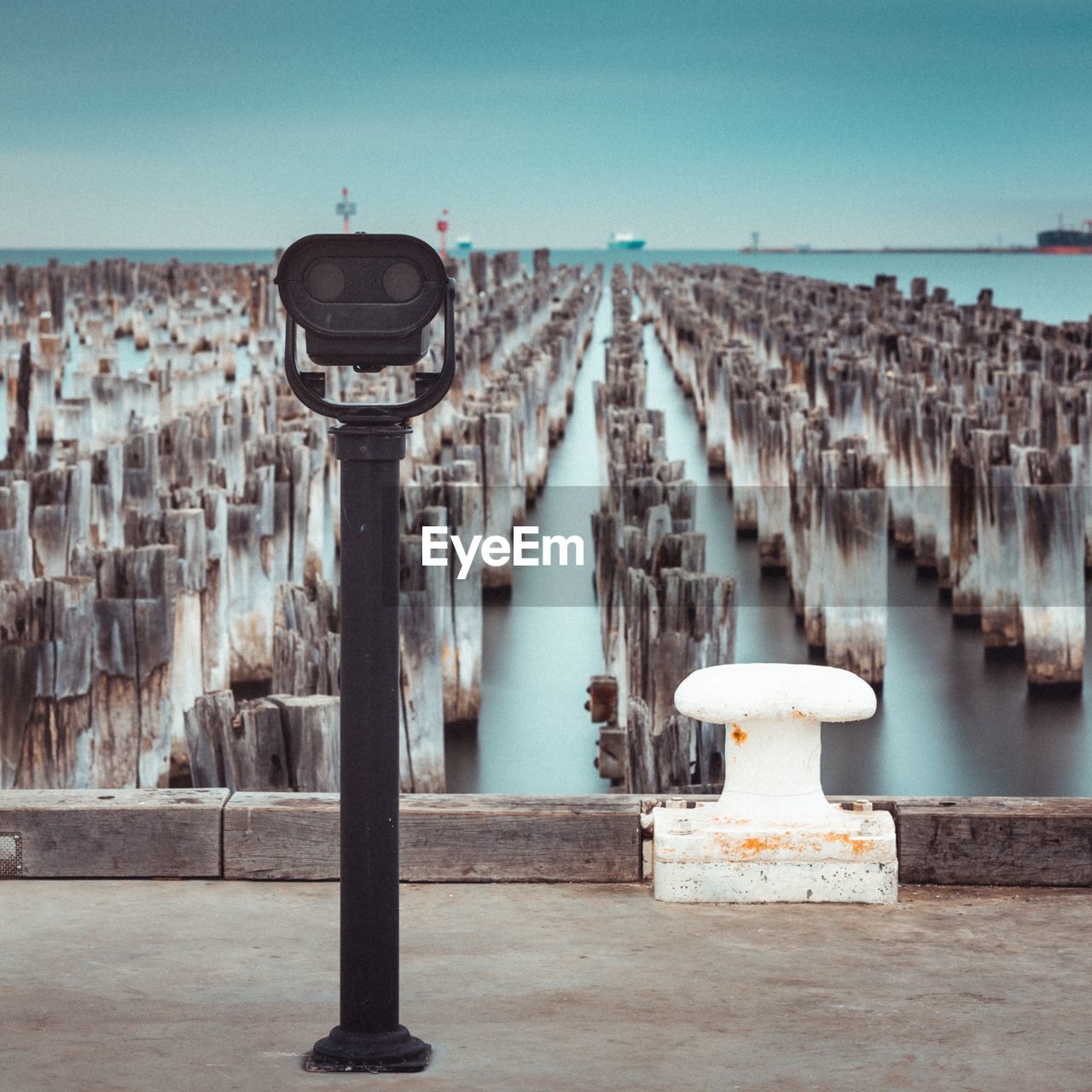 Panoramic view of wooden posts in sea against clear sky