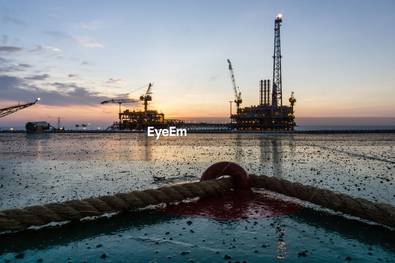 Sunset at oilfield viewed from a helipad of a construction barge