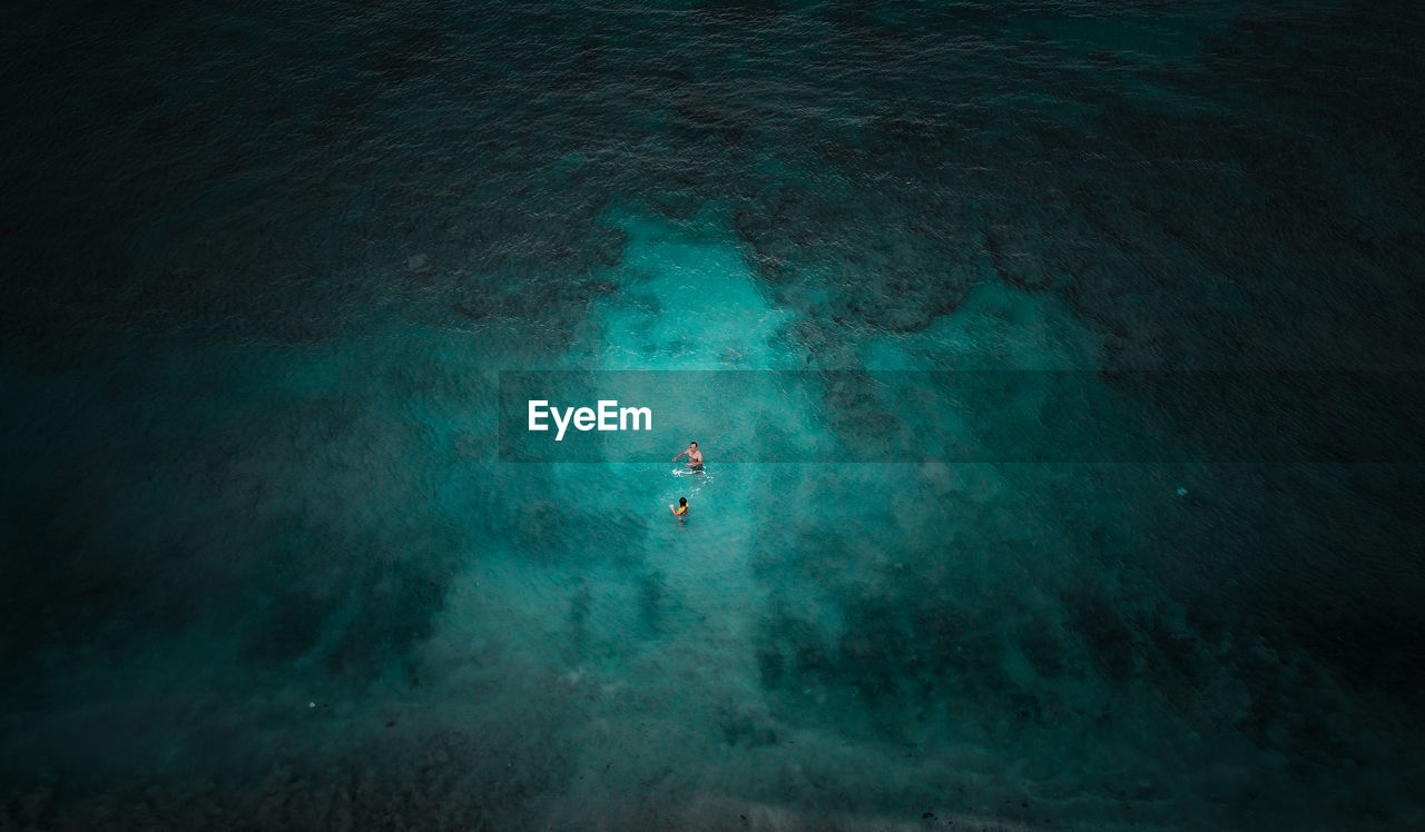 High angle view of people swimming in sea