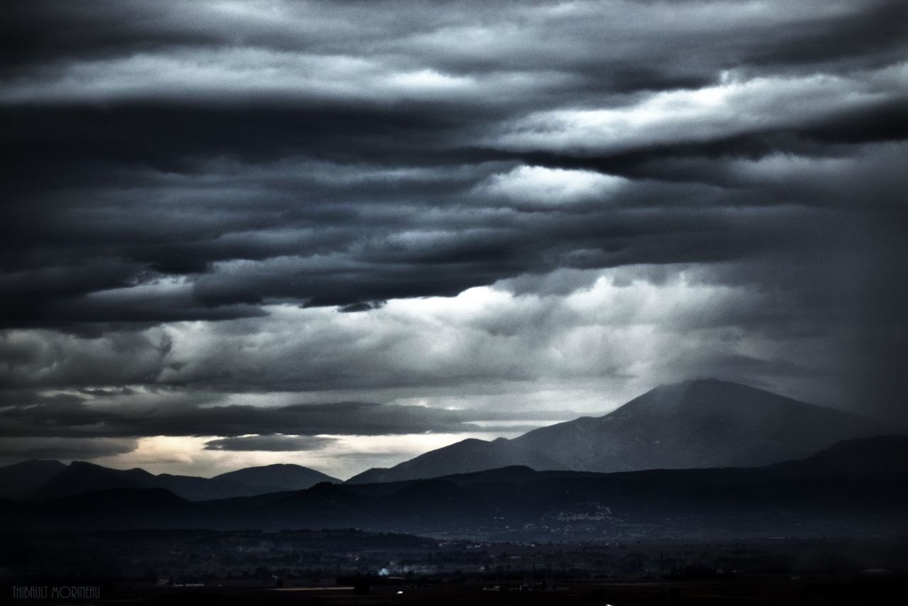 SILHOUETTE OF MOUNTAIN AGAINST CLOUDY SKY