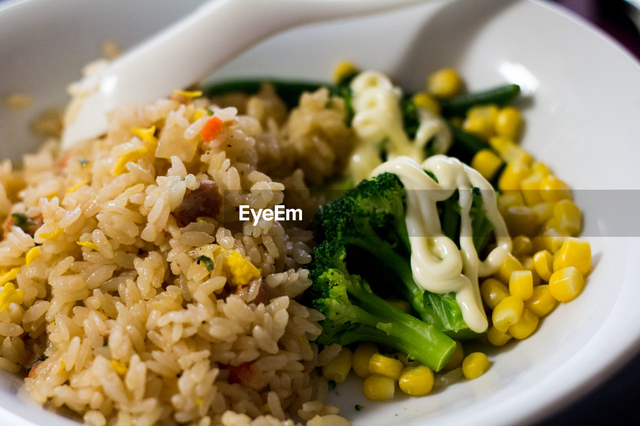 CLOSE-UP OF RICE WITH VEGETABLES IN PLATE
