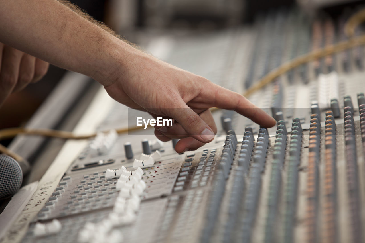 Close-up of hand using sound mixer