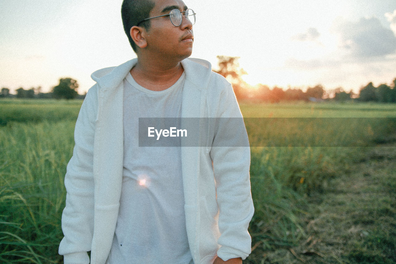 Portrait of man standing on field
