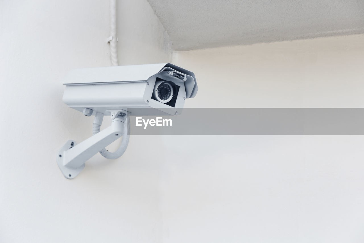 Close-up of security camera on wall