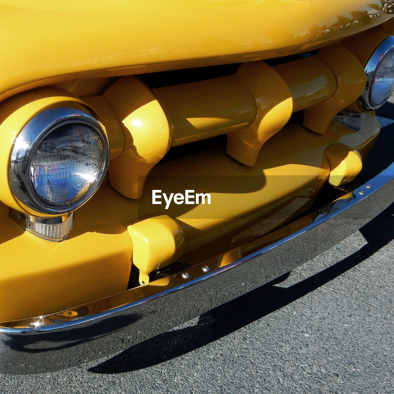 High angle view of headlights on yellow car