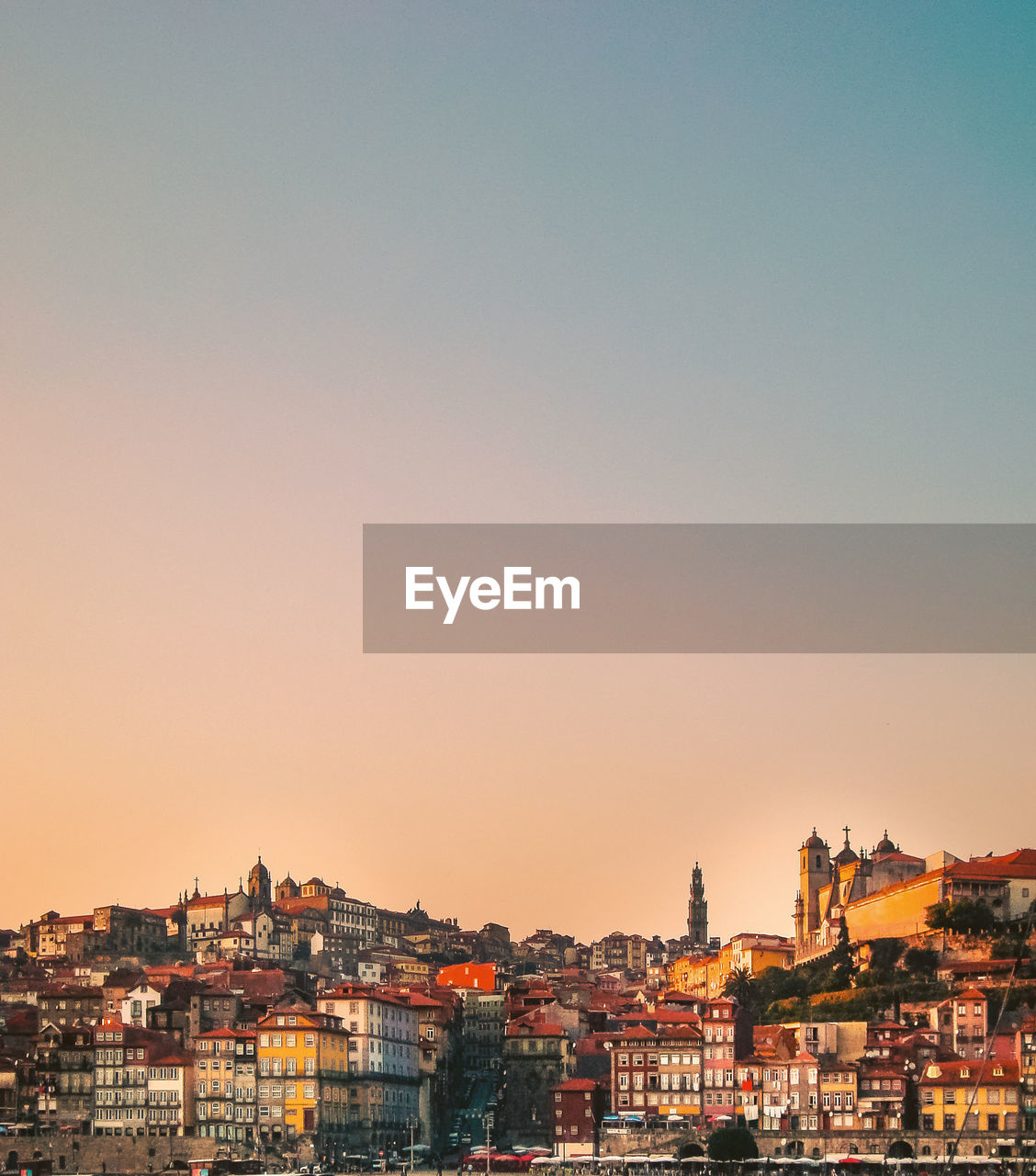 Buildings in city against clear sky during sunset, porto city portugal