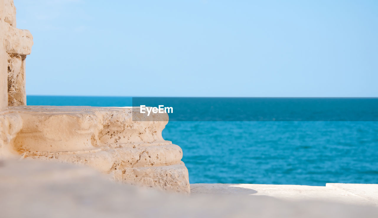 Detail of old italian architecture in trani and blue sea background apulia italy
