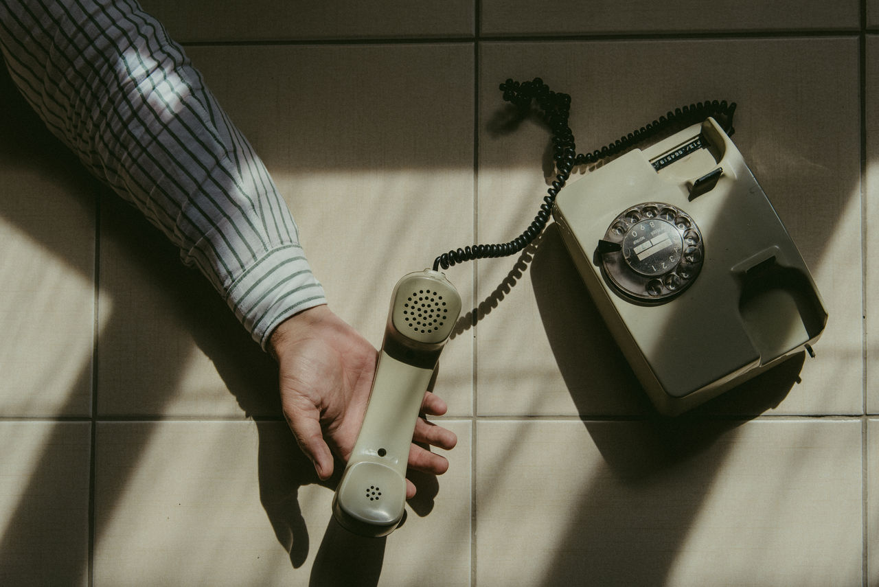 Low section of person holding telephone