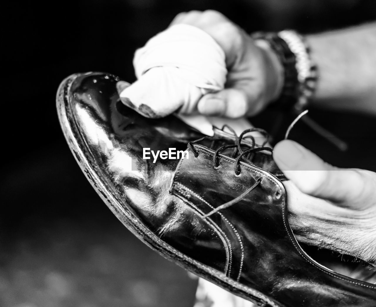 Cropped image of hands polishing shoe